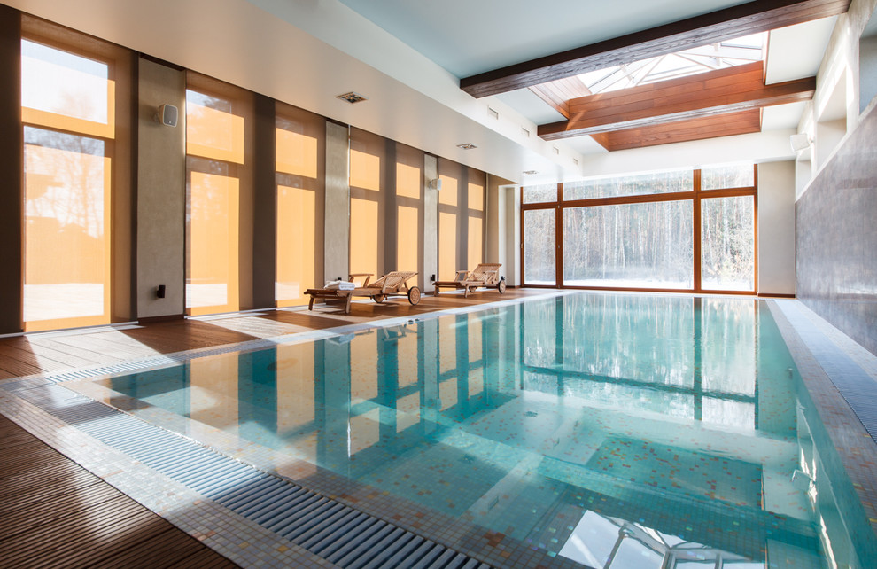This is an example of a large contemporary indoor rectangular lengths swimming pool in Moscow with decking.