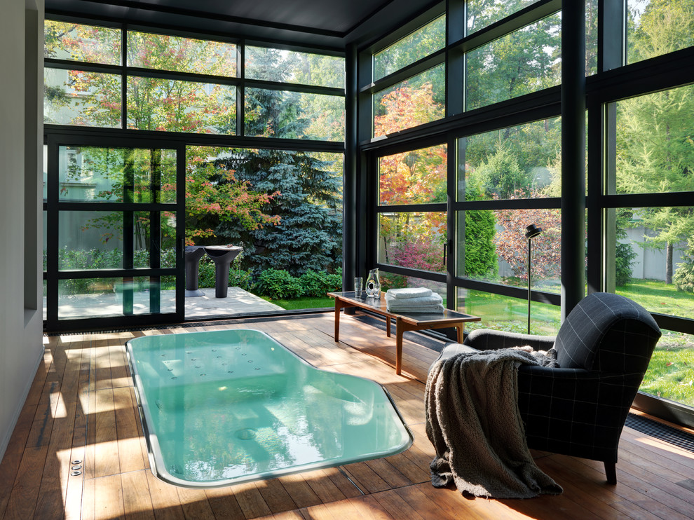 Idée de décoration pour une piscine design sur mesure avec une terrasse en bois.