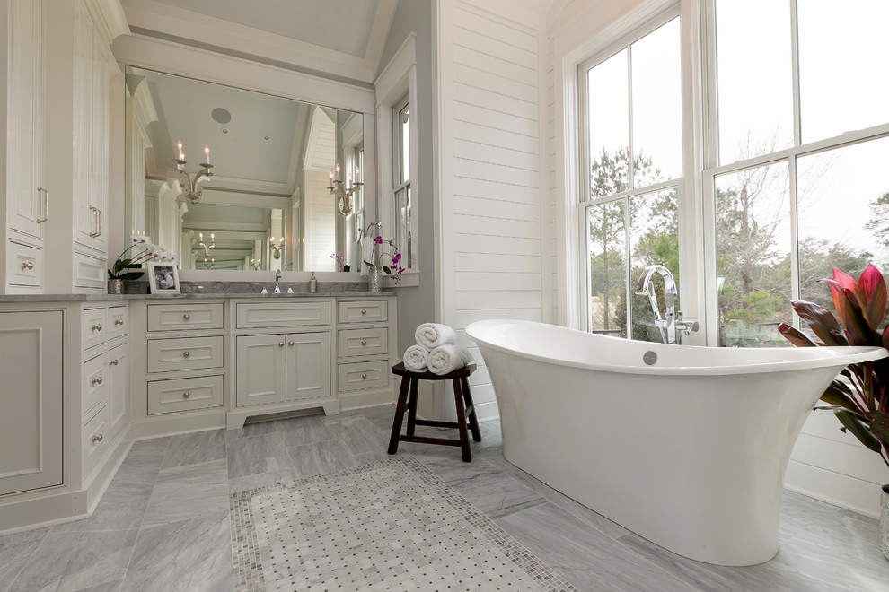 This is an example of a traditional bathroom in Charleston with recessed-panel cabinets, grey cabinets and grey tiles.