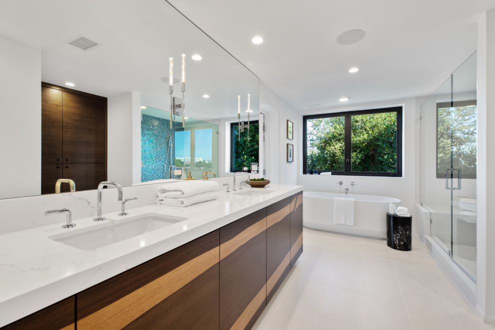 На фото: ванная комната в современном стиле с плоскими фасадами, темными деревянными фасадами, врезной раковиной, серым полом, белой столешницей, тумбой под две раковины и встроенной тумбой