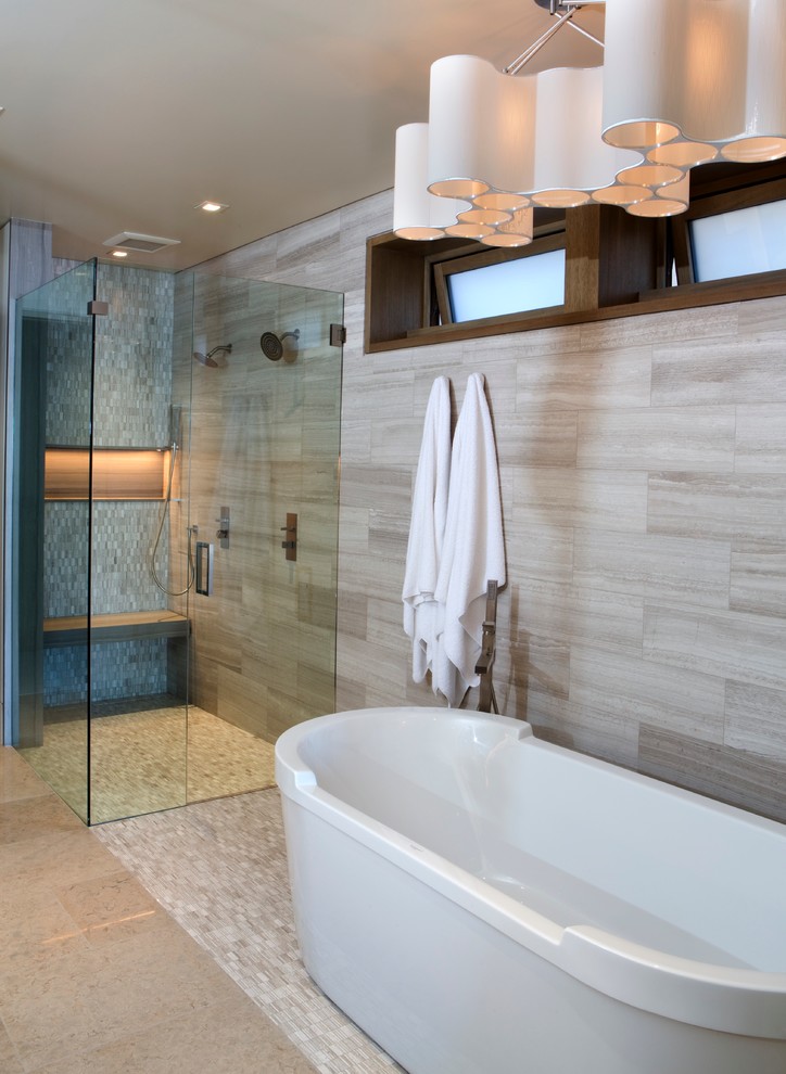 Inspiration for a large modern ensuite bathroom in Orange County with a freestanding bath, a corner shower, beige tiles, porcelain tiles, beige walls, ceramic flooring, beige floors, a hinged door, flat-panel cabinets, dark wood cabinets, a submerged sink and engineered stone worktops.