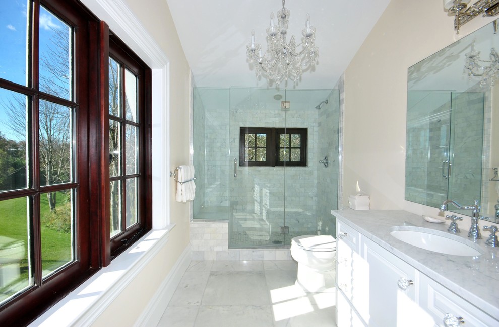 マイアミにあるトラディショナルスタイルのおしゃれな浴室 (アンダーカウンター洗面器、白いキャビネット、アルコーブ型シャワー、白いタイル) の写真