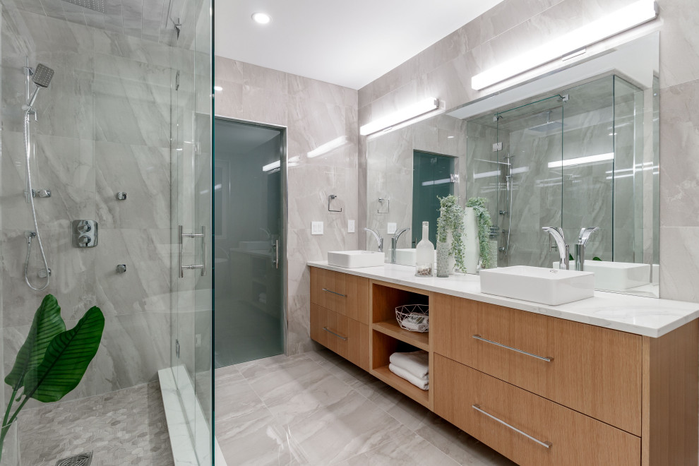 Example of a trendy gray tile gray floor and double-sink bathroom design in Vancouver with flat-panel cabinets, medium tone wood cabinets, a vessel sink and white countertops
