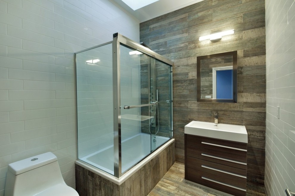 Bathroom - mid-sized transitional kids' vinyl floor and brown floor bathroom idea in New York with flat-panel cabinets, medium tone wood cabinets, a one-piece toilet, white walls and a vessel sink