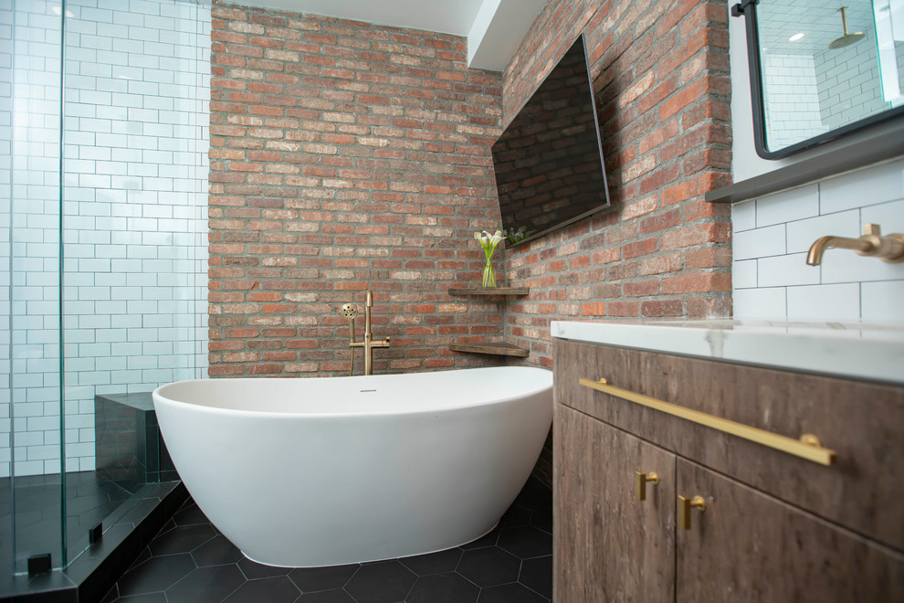 Contemporary ensuite bathroom in Los Angeles with flat-panel cabinets, brown cabinets, a freestanding bath, a corner shower, white tiles, metro tiles, multi-coloured walls, cement flooring, a submerged sink, engineered stone worktops, black floors, a hinged door and white worktops.
