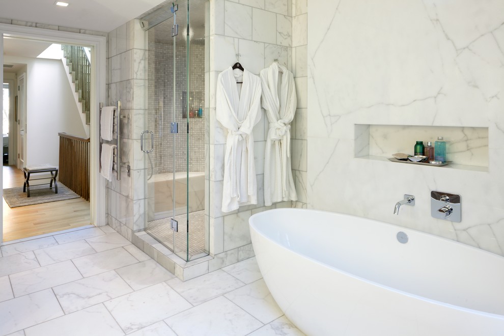 Traditional ensuite bathroom in New York with flat-panel cabinets, brown cabinets, a freestanding bath, a corner shower, yellow tiles, marble tiles, white walls, marble flooring, a submerged sink, marble worktops, white floors and a hinged door.