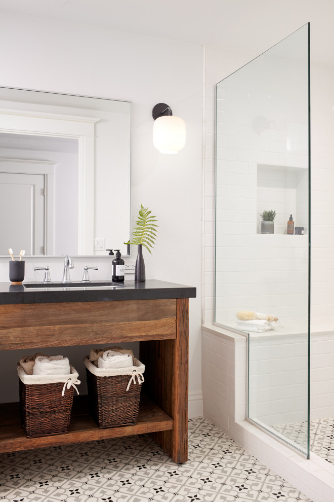 Inspiration for a transitional white tile multicolored floor and single-sink alcove shower remodel in San Francisco with flat-panel cabinets, dark wood cabinets, white walls, an undermount sink, a hinged shower door, black countertops and a freestanding vanity