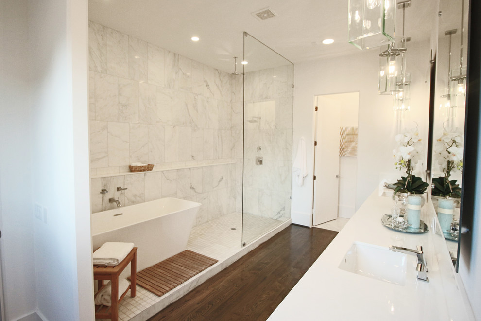Example of a large trendy master white tile dark wood floor bathroom design in Houston with an undermount sink, flat-panel cabinets, white cabinets, a one-piece toilet and white walls