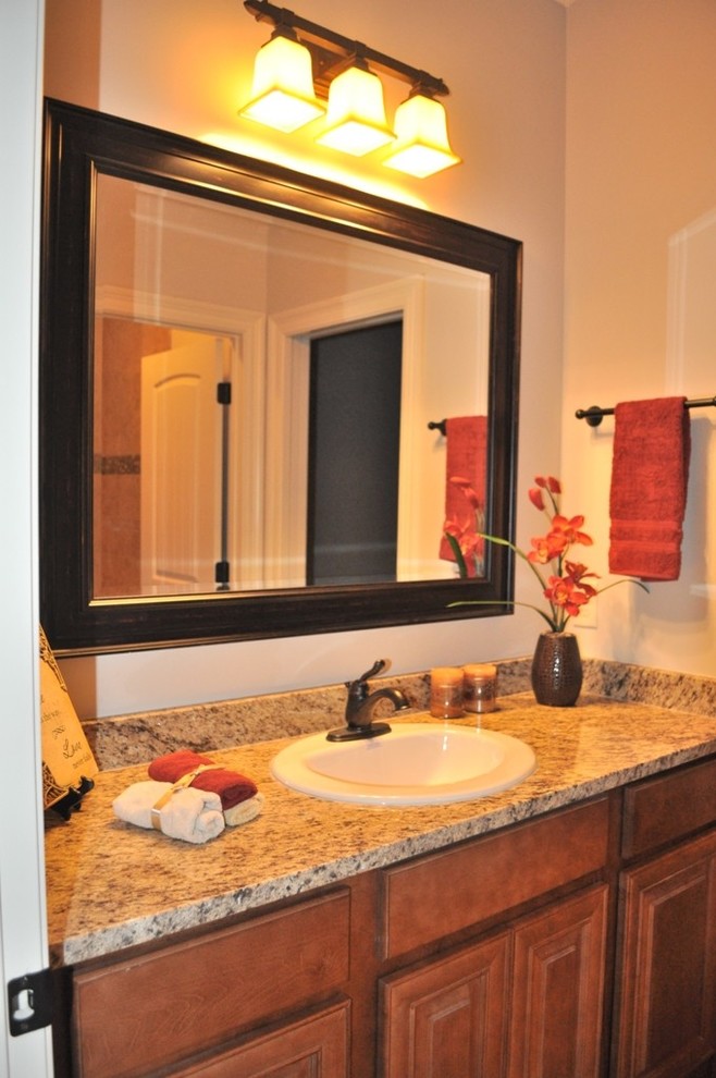 Example of a large classic kids' beige tile and porcelain tile porcelain tile bathroom design in Miami with raised-panel cabinets, medium tone wood cabinets, a two-piece toilet, beige walls, an undermount sink and granite countertops