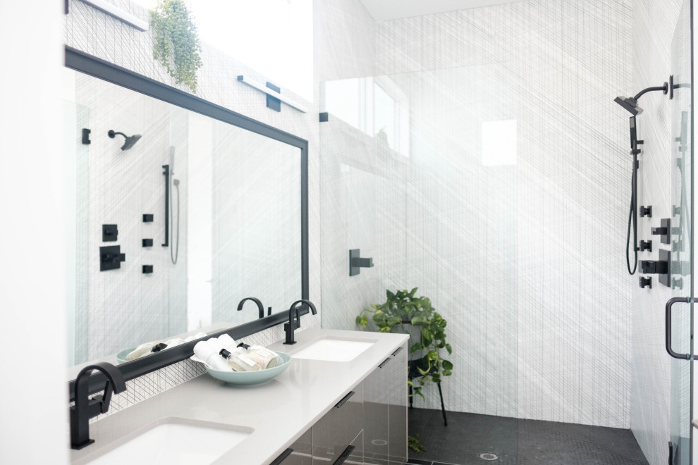 Example of a trendy white tile black floor and double-sink alcove shower design in Atlanta with flat-panel cabinets, gray cabinets, an undermount sink and gray countertops