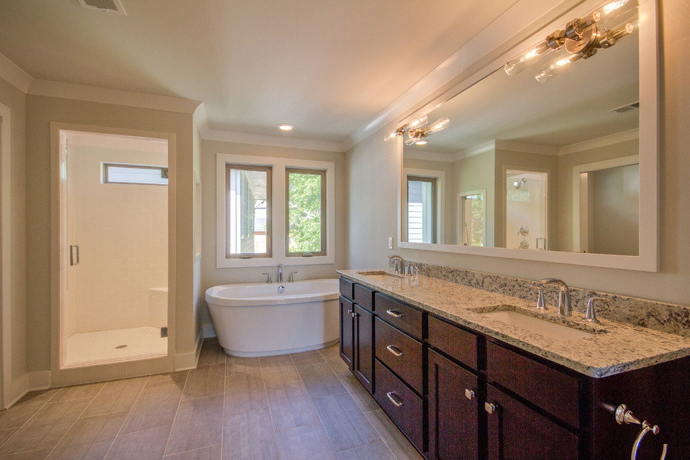 Mid-sized arts and crafts master gray tile and porcelain tile porcelain tile bathroom photo in Nashville with an undermount sink, shaker cabinets, dark wood cabinets, granite countertops, a two-piece toilet and gray walls