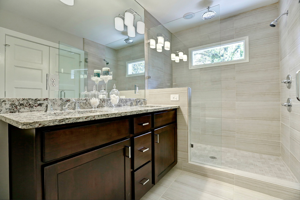 Elegant beige tile and porcelain tile doorless shower photo in Atlanta with an undermount sink, shaker cabinets, dark wood cabinets and granite countertops