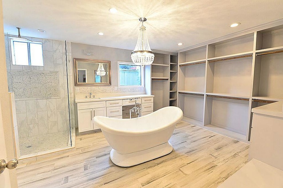 Example of a mid-sized transitional master white tile and stone tile vinyl floor and gray floor bathroom design in Houston with shaker cabinets, white cabinets, gray walls, an undermount sink, quartzite countertops and a hinged shower door
