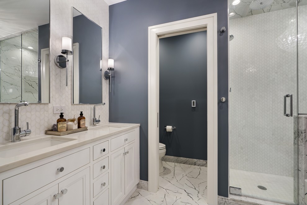 Идея дизайна: ванная комната в стиле неоклассика (современная классика) с фасадами с утопленной филенкой, белыми фасадами, душем в нише, белой плиткой, синими стенами, врезной раковиной, белым полом, душем с распашными дверями и белой столешницей