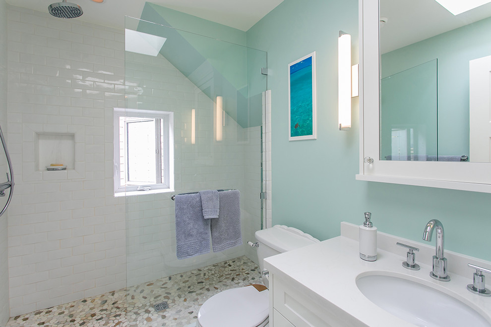Inspiration for a medium sized traditional shower room bathroom in Vancouver with shaker cabinets, white cabinets, an alcove shower, a two-piece toilet, white tiles, metro tiles, blue walls, pebble tile flooring, a submerged sink, engineered stone worktops, beige floors and an open shower.
