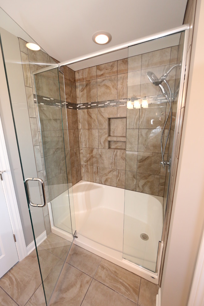 Photo of a large traditional ensuite bathroom in Chicago with a submerged sink, shaker cabinets, dark wood cabinets, granite worktops, an alcove shower, a two-piece toilet, brown tiles, ceramic tiles, brown walls and ceramic flooring.