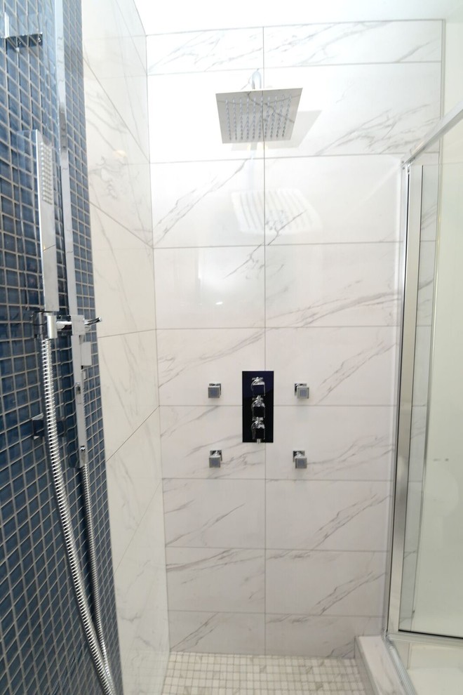Photo of a medium sized contemporary ensuite bathroom in Other with flat-panel cabinets, blue cabinets, a freestanding bath, a shower/bath combination, a two-piece toilet, white tiles, ceramic tiles, white walls, ceramic flooring, a vessel sink and quartz worktops.