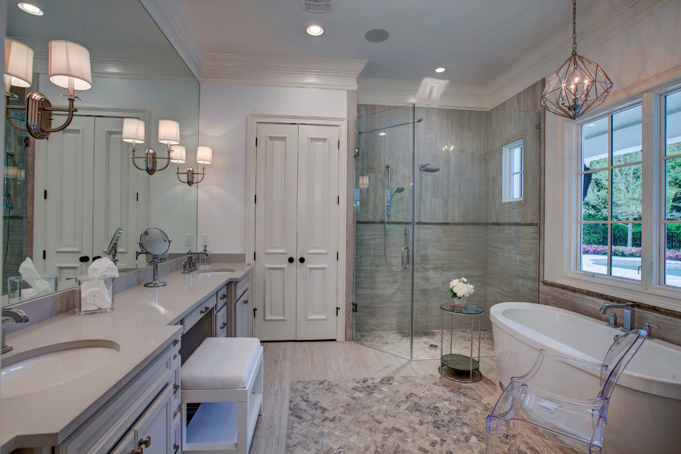 Inspiration for a transitional master gray tile and stone tile travertine floor bathroom remodel in Orlando with an undermount sink, white walls, white cabinets and quartz countertops