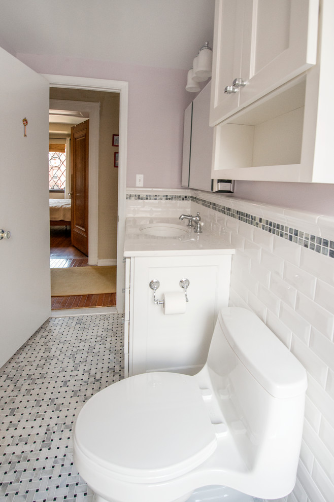 Inspiration for a mid-sized transitional white tile and subway tile marble floor bathroom remodel in DC Metro with an undermount sink, shaker cabinets, white cabinets, quartz countertops, a one-piece toilet and purple walls