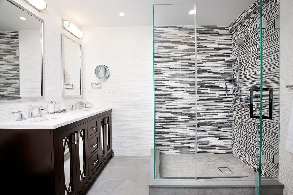 Mid-sized transitional master black tile, black and white tile, gray tile, white tile and matchstick tile ceramic tile and gray floor corner shower photo in New York with shaker cabinets, dark wood cabinets, white walls, an undermount sink, quartzite countertops and a hinged shower door