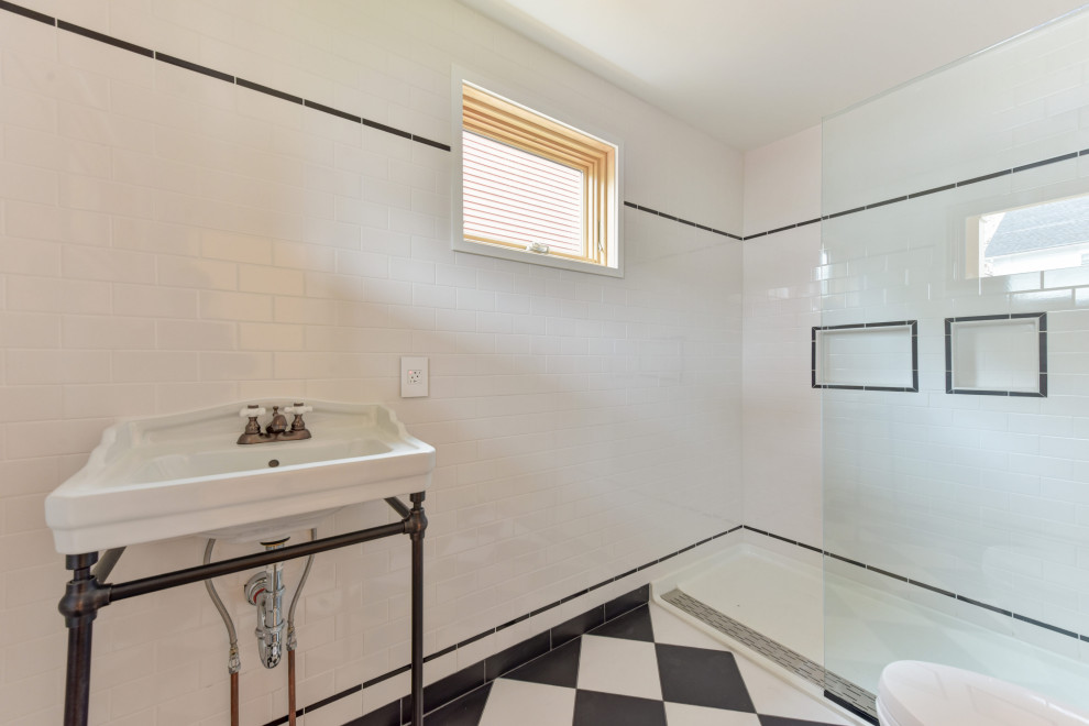 Photo of a medium sized modern bathroom in DC Metro with an alcove shower, a one-piece toilet, white tiles, white walls, a pedestal sink, multi-coloured floors and an open shower.