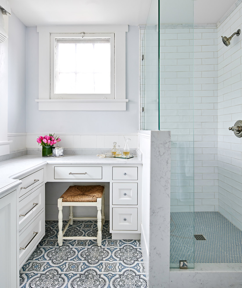 Inspiration for a small traditional family bathroom in Austin with shaker cabinets, white cabinets, a corner shower, a two-piece toilet, white tiles, ceramic tiles, blue walls, marble flooring, a submerged sink, engineered stone worktops, blue floors, a hinged door and white worktops.