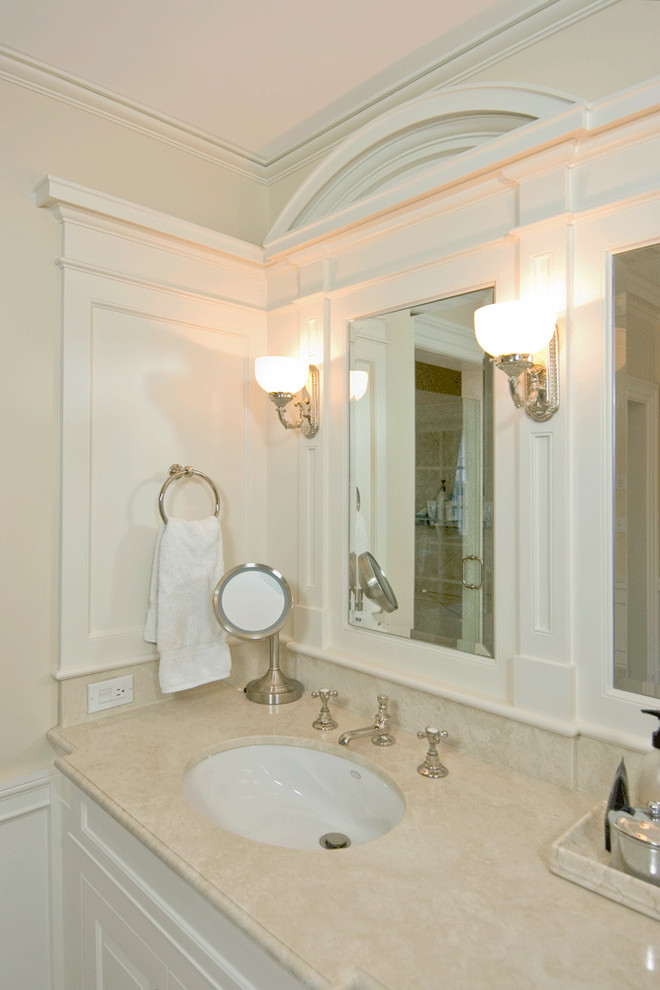 На фото: большая главная ванная комната в классическом стиле с фасадами с выступающей филенкой, белыми фасадами, столешницей из гранита, бежевой плиткой, ванной на ножках, душем в нише, каменной плиткой, бежевыми стенами, полом из травертина и врезной раковиной