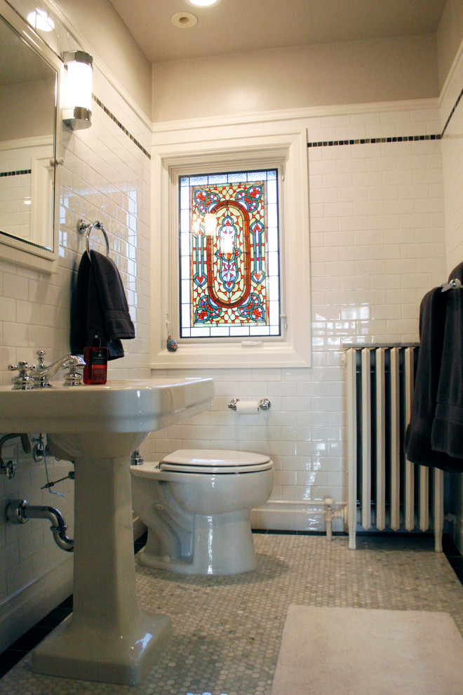 This is an example of a medium sized classic shower room bathroom in Detroit with a two-piece toilet, white tiles, metro tiles, white walls, mosaic tile flooring, a pedestal sink and grey floors.
