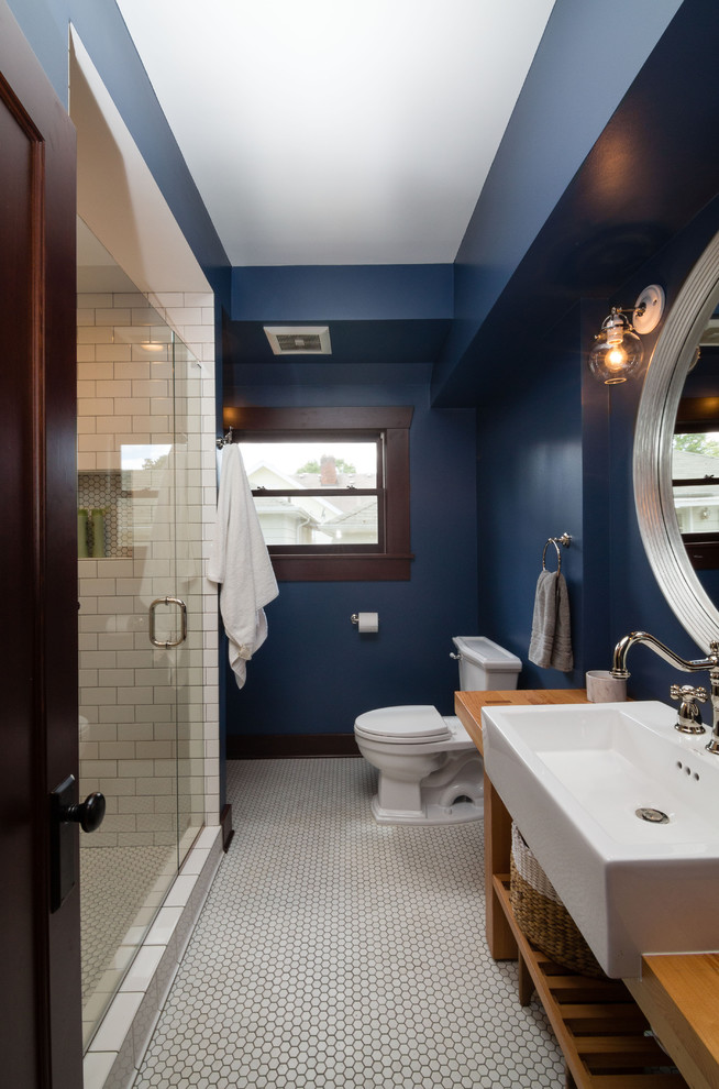 Inspiration for a medium sized traditional shower room bathroom in Portland with open cabinets, medium wood cabinets, an alcove shower, white tiles, metro tiles, blue walls, ceramic flooring, wooden worktops and a vessel sink.