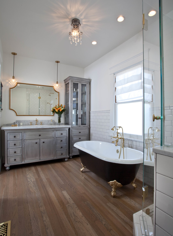 Example of an arts and crafts 3/4 white tile and subway tile medium tone wood floor bathroom design in San Diego with shaker cabinets, white cabinets, white walls and an undermount sink