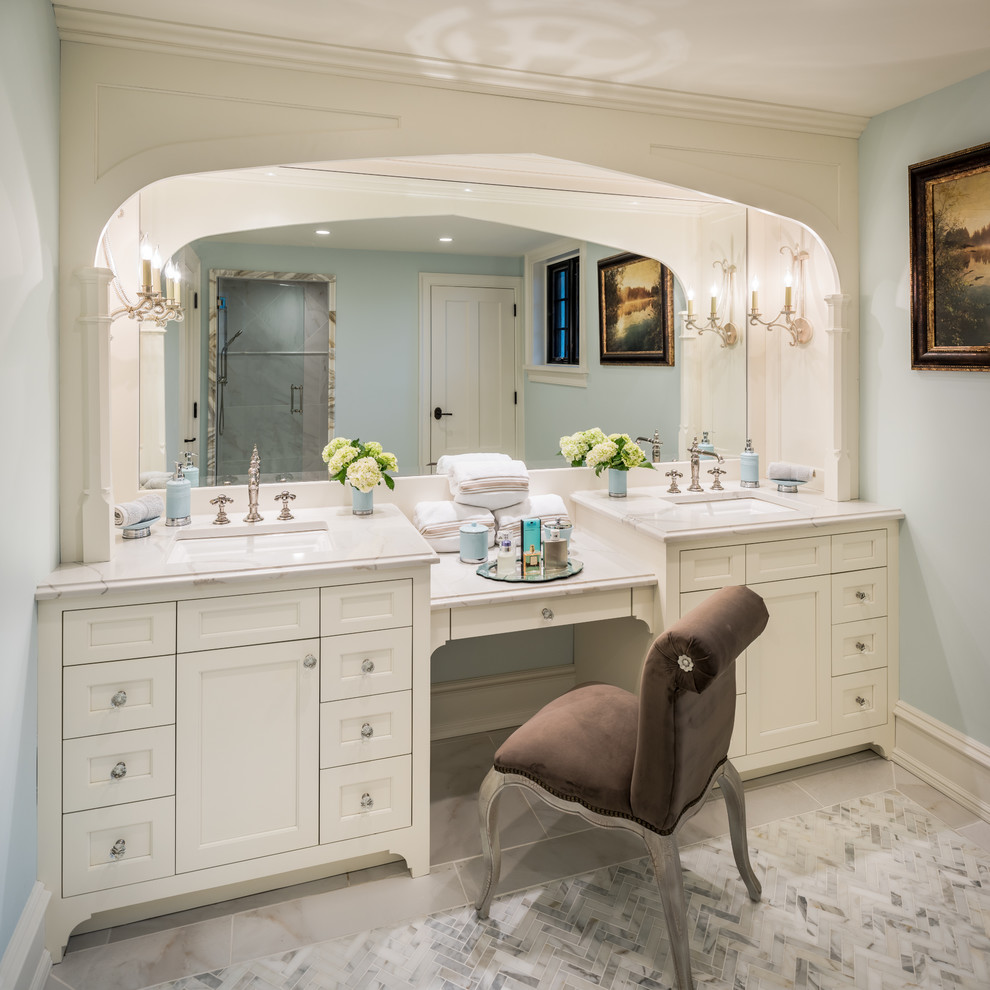 Example of a large classic master stone tile and white tile marble floor alcove shower design in Philadelphia with shaker cabinets, white cabinets, blue walls, an undermount sink and marble countertops