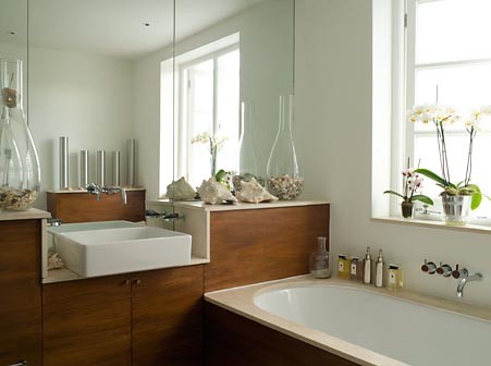 Medium sized traditional family bathroom in London with a trough sink, flat-panel cabinets, medium wood cabinets, limestone worktops, a built-in bath, a walk-in shower, a one-piece toilet, beige tiles, stone tiles, white walls and limestone flooring.