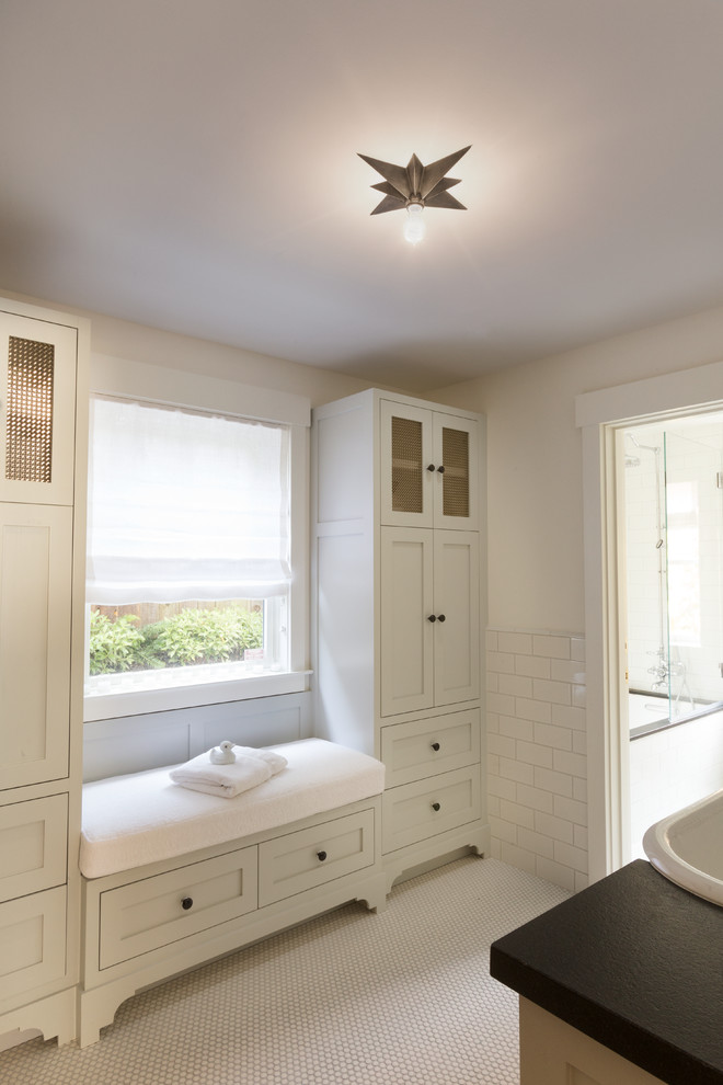 Exemple d'une salle de bain principale chic avec une vasque, un placard avec porte à panneau encastré, des portes de placard blanches, un carrelage blanc, un carrelage métro, un mur blanc et un sol en carrelage de terre cuite.