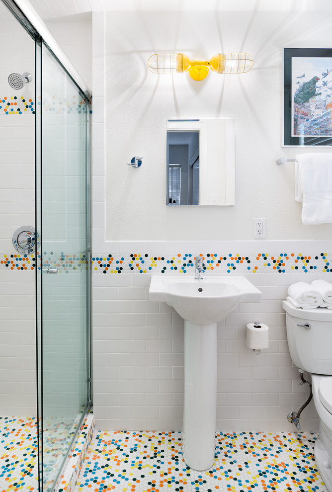 Diseño de cuarto de baño retro pequeño con armarios con paneles lisos, puertas de armario blancas, baldosas y/o azulejos blancos, baldosas y/o azulejos de cemento, sanitario de dos piezas, lavabo con pedestal, paredes blancas y suelo de baldosas de porcelana