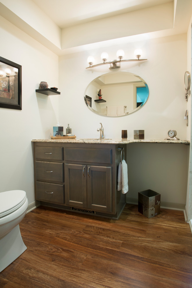 Example of a mid-sized mid-century modern master light wood floor walk-in shower design in Milwaukee with an undermount sink, recessed-panel cabinets, gray cabinets, quartz countertops, a two-piece toilet and white walls