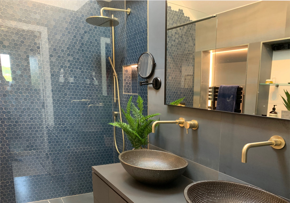 Design ideas for a medium sized contemporary family bathroom in Surrey with flat-panel cabinets, a walk-in shower, blue tiles, ceramic tiles, multi-coloured walls, double sinks and a floating vanity unit.