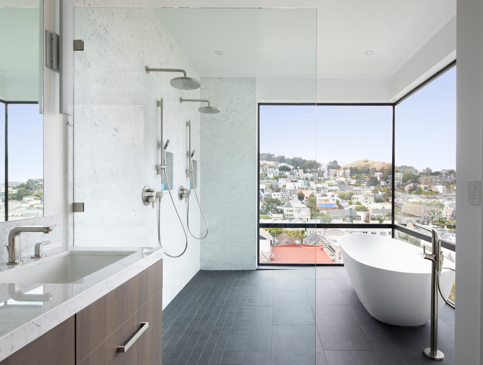 Freestanding bathtub - contemporary black floor freestanding bathtub idea in San Francisco with flat-panel cabinets, dark wood cabinets, an undermount sink and white countertops