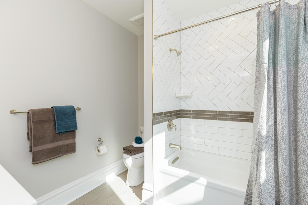 Inspiration for a traditional ensuite bathroom in St Louis with dark wood cabinets, an alcove bath, a walk-in shower, white tiles, ceramic tiles, beige walls and ceramic flooring.