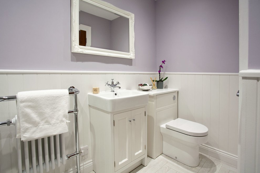 Inspiration for a medium sized classic family bathroom in Sussex with shaker cabinets, white cabinets, a freestanding bath, a corner shower, a one-piece toilet, grey tiles, ceramic tiles, purple walls, porcelain flooring, a trough sink, marble worktops, grey floors and a hinged door.