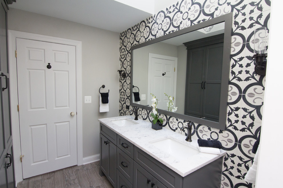Bathroom - mid-sized transitional kids' multicolored tile and ceramic tile porcelain tile and multicolored floor bathroom idea in Chicago with recessed-panel cabinets, gray cabinets, a two-piece toilet, gray walls, an undermount sink, quartz countertops, a hinged shower door and multicolored countertops