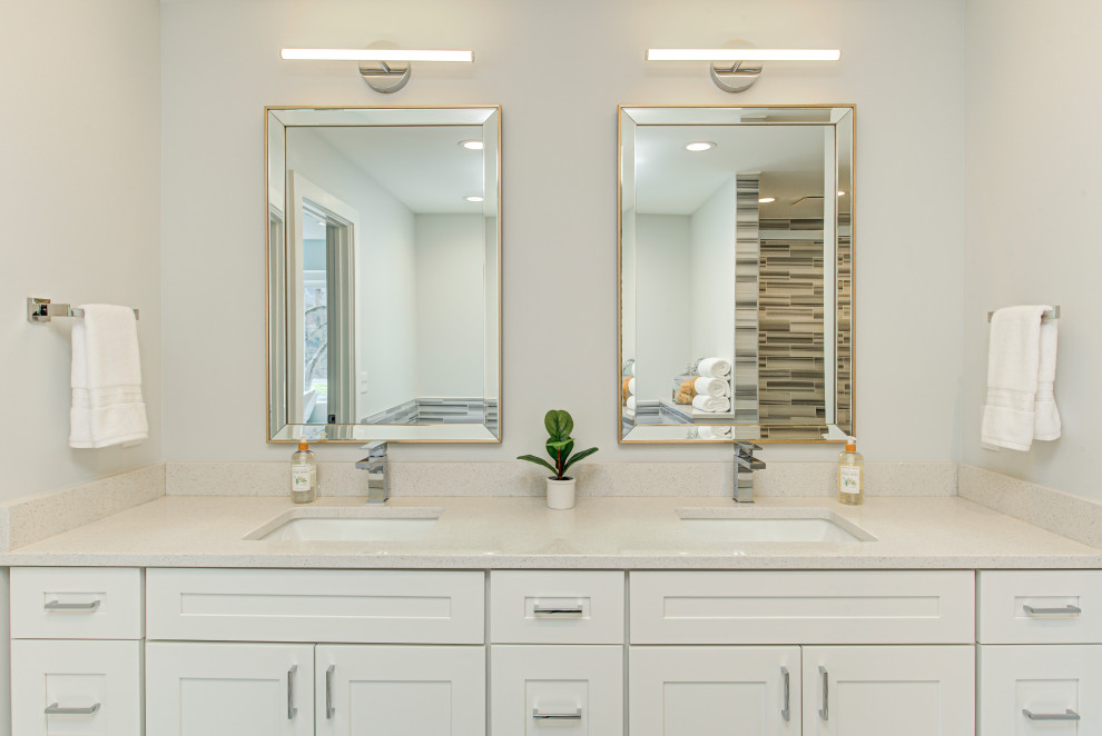 Medium sized contemporary ensuite bathroom in Indianapolis with flat-panel cabinets, beige cabinets, a freestanding bath, black and white tiles, ceramic tiles, multi-coloured walls, ceramic flooring, a built-in sink, granite worktops, multi-coloured floors, beige worktops, a wall niche, double sinks and a built in vanity unit.