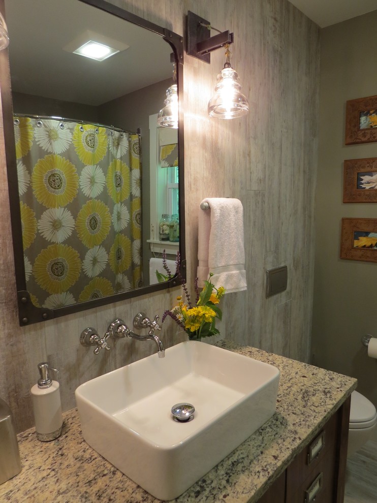 Mid-sized eclectic multicolored tile and porcelain tile porcelain tile tub/shower combo photo in Portland Maine with a vessel sink, flat-panel cabinets, medium tone wood cabinets, granite countertops, a wall-mount toilet and gray walls