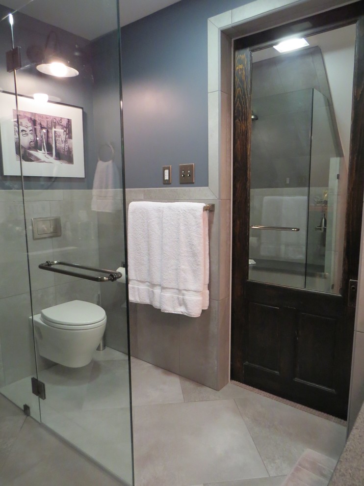 Inspiration for a small urban ensuite bathroom in Portland Maine with a submerged sink, shaker cabinets, dark wood cabinets, granite worktops, a built-in shower, a wall mounted toilet, grey tiles, porcelain tiles, grey walls and porcelain flooring.