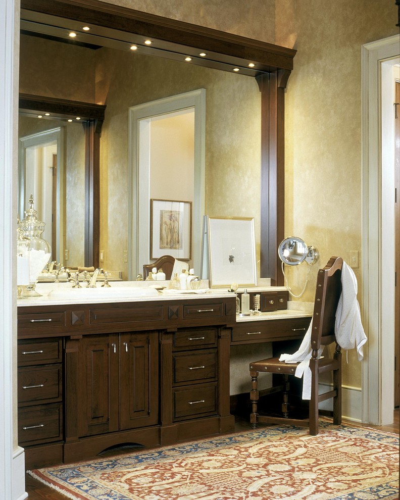 Inspiration for a traditional bathroom in New York with raised-panel cabinets and dark wood cabinets.