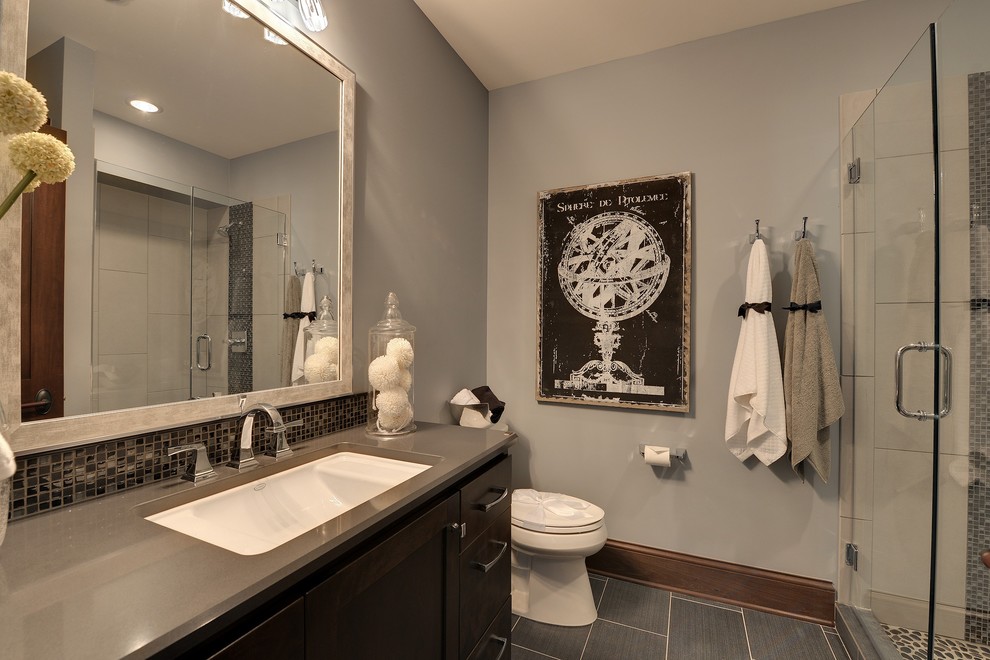 Photo of a traditional bathroom in Minneapolis with a submerged sink, shaker cabinets, dark wood cabinets, an alcove shower, grey tiles and mosaic tiles.