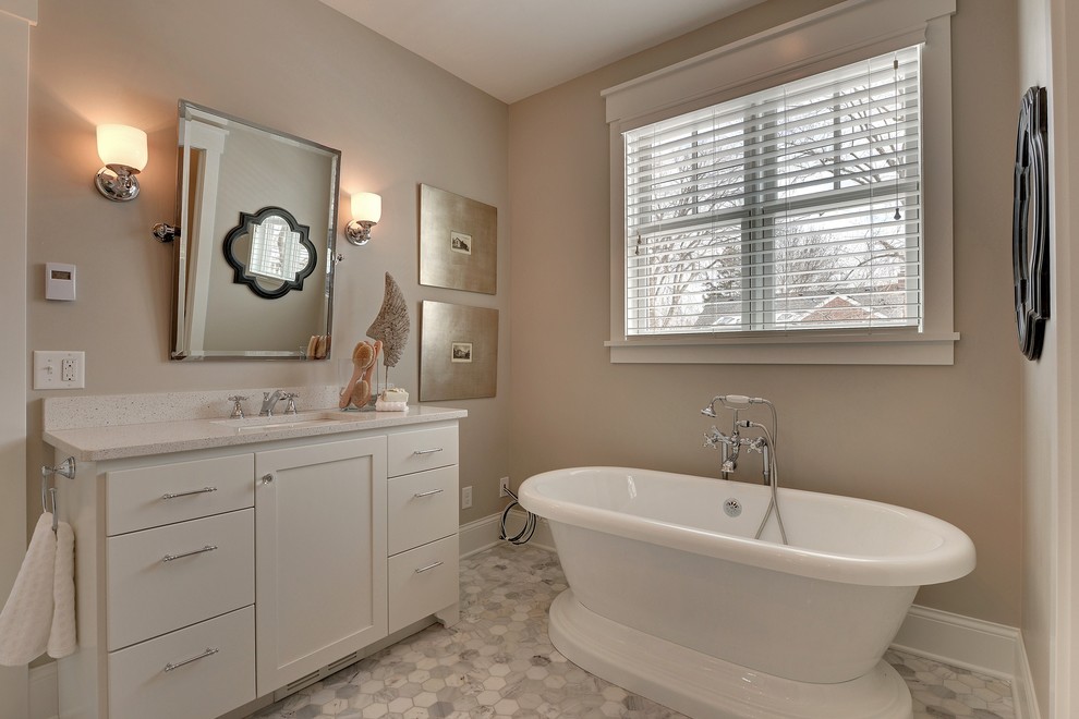 Photo of a classic bathroom in Minneapolis with a submerged sink, shaker cabinets, white cabinets, a freestanding bath and white tiles.