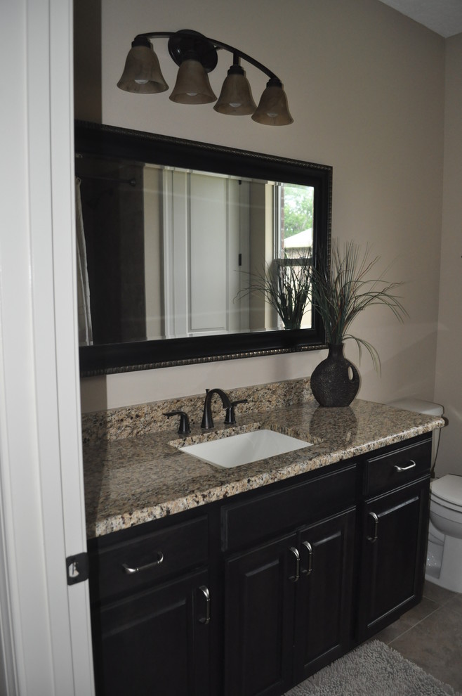 Bathroom - mid-sized traditional bathroom idea in Miami with an undermount sink, raised-panel cabinets, black cabinets and granite countertops