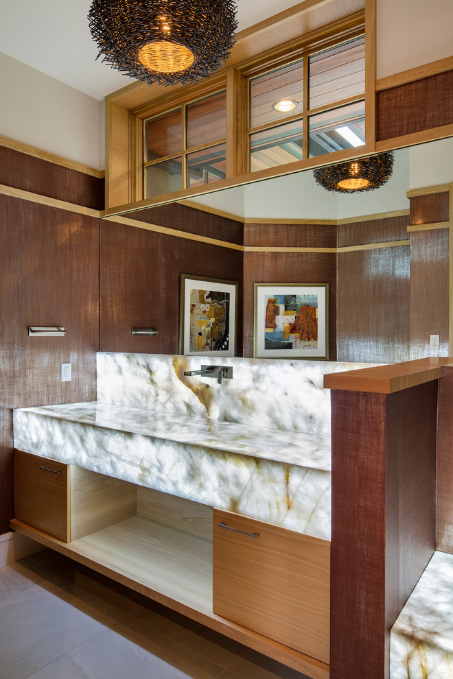 Inspiration pour une salle d'eau design en bois clair de taille moyenne avec un lavabo encastré, un placard à porte plane, un plan de toilette en quartz, un carrelage beige, un carrelage de pierre, un mur marron et un sol en carrelage de porcelaine.