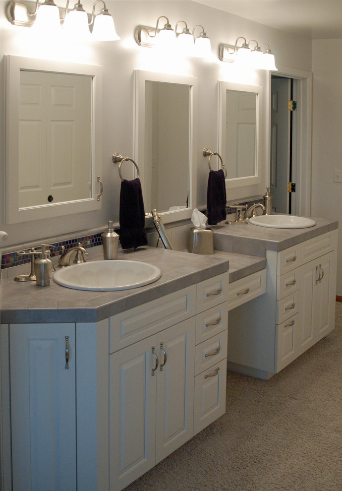 Photo of a small classic ensuite bathroom in San Luis Obispo with a built-in sink, raised-panel cabinets, white cabinets, tiled worktops, grey tiles, ceramic tiles and grey walls.