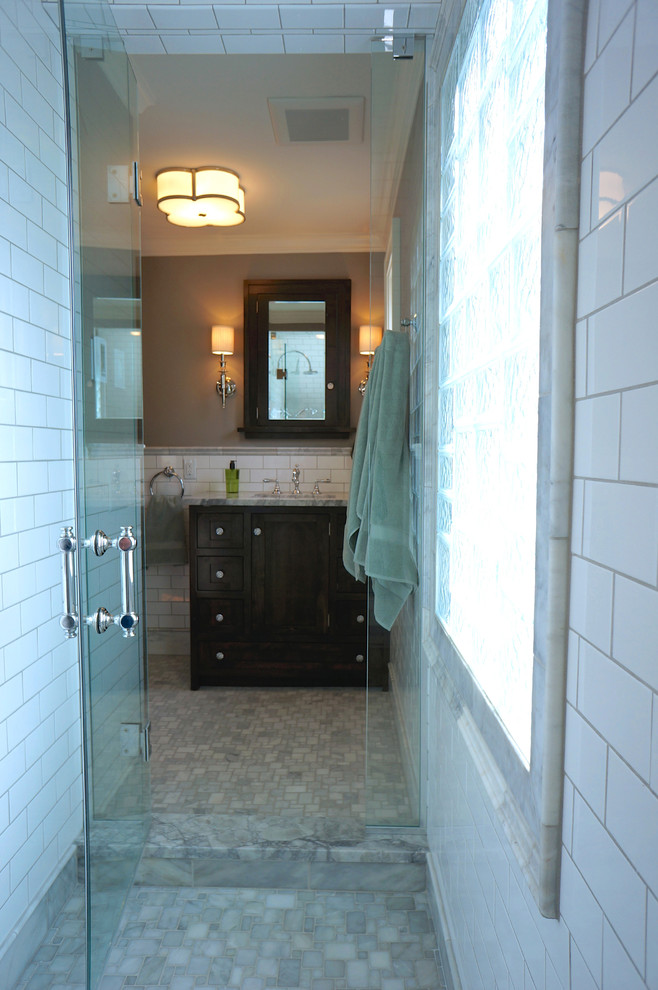 Alcove shower - mid-sized traditional master white tile and subway tile marble floor alcove shower idea in Minneapolis with an undermount sink, flat-panel cabinets, dark wood cabinets, marble countertops, a one-piece toilet and gray walls